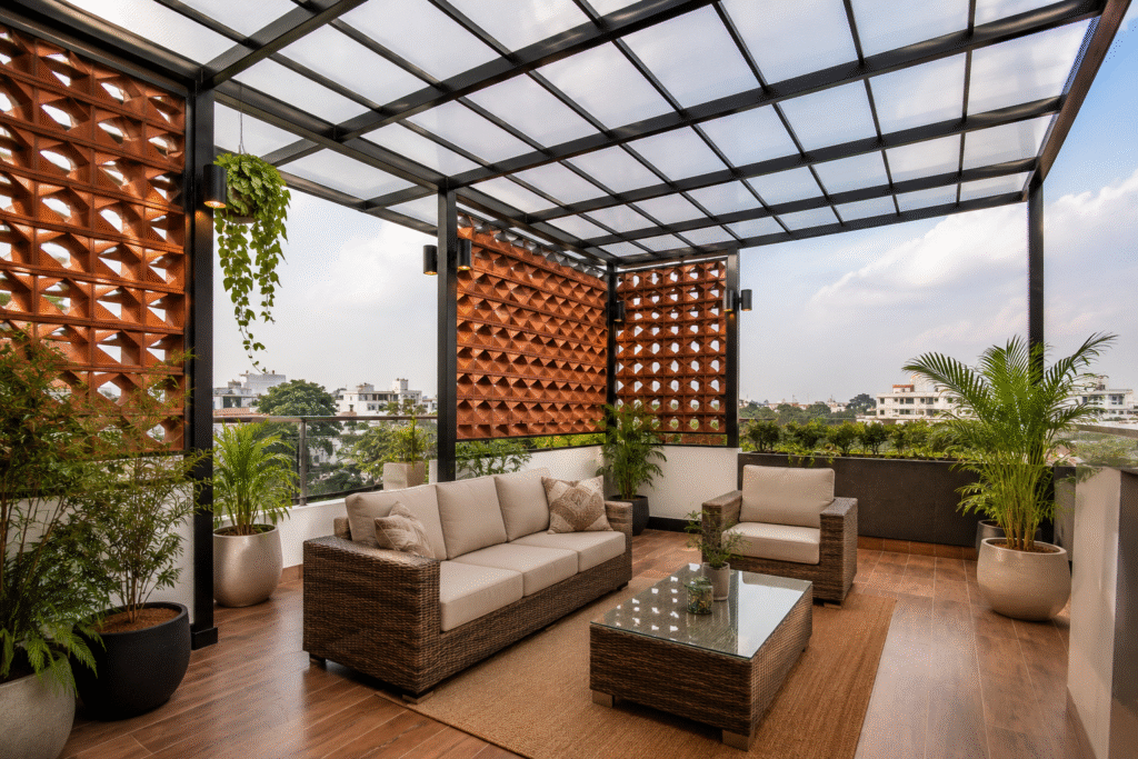 Terrace Makeover Hyderabad with terracotta brick privacy walls, metal pergola framework, clear polycarbonate roofing, greenery, and outdoor seating.